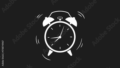 Vintage black alarm clock with white face and metal bells isolated on a black background, a perfect retro object for a morning reminder
