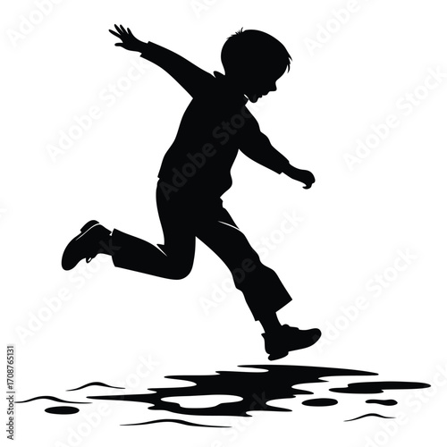 Child jumping into puddle