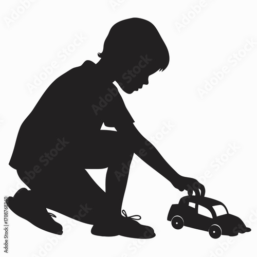 Boy squatting with toy car