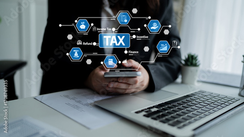 A businessman interacts with a smartphone while icons related to tax and finance emerge digitally in a modern office environment, portraying efficiency and innovation. Tessel