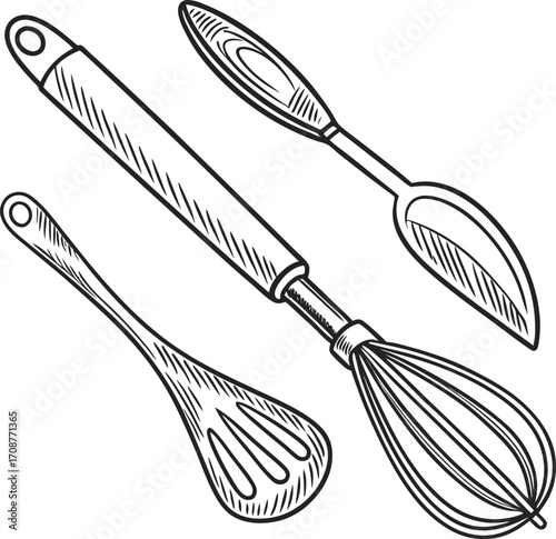 Metal wire whisk and other cooking utensils isolated on a white background