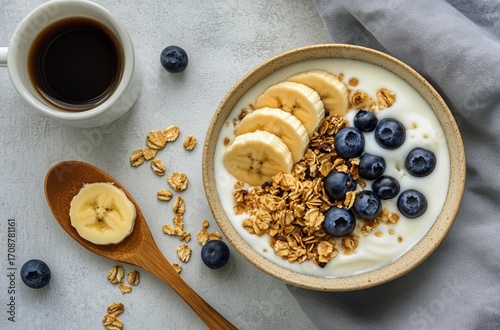Healthy Breakfast Bowl With Yogurt, Granola, and Fresh Fruit on a Rustic Table.