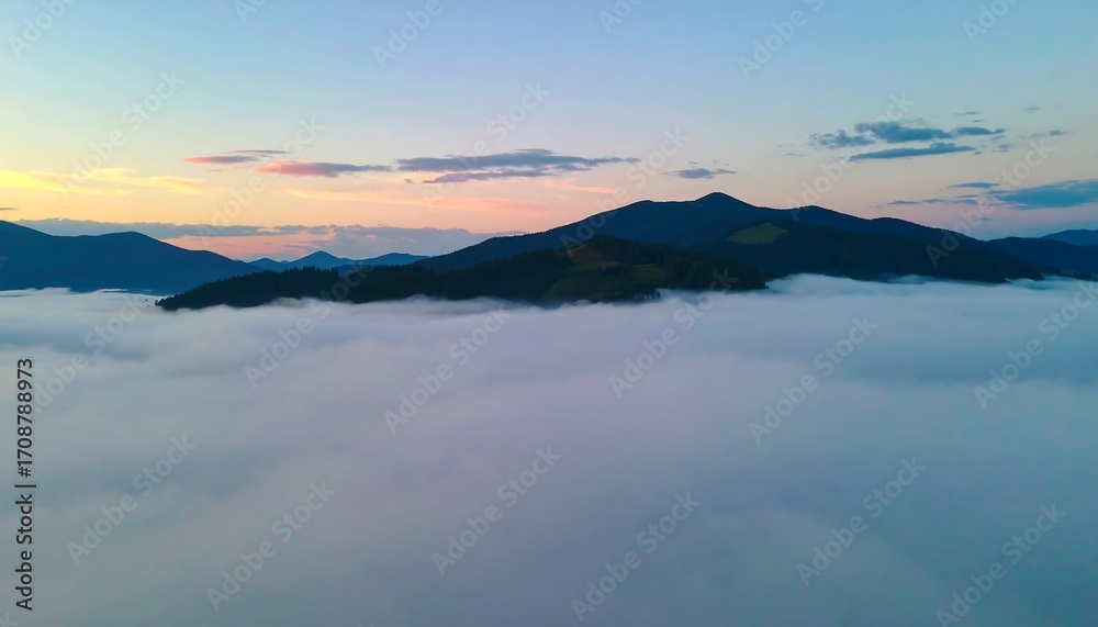Fototapeta premium Misty mountain peaks at dawn