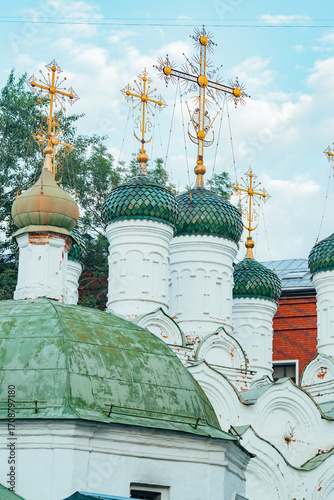 Church domes with colorful onion-shaped tops under blue sky
