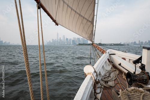 Sailing Past the Skyline of a Bustling City Near the Shore