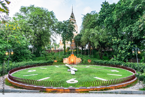 Flower clock showing time and wat phnom in background in phnom penh, cambodia