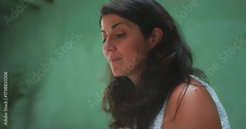 Beautiful woman smiling at tea with steam in foreground, close-up