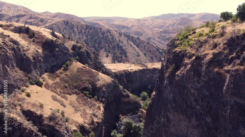 Aerial view in a basalt rock canyon in Garni, Armenia. Desert environment with vast mountain range and popular tourist destination for the unique views.