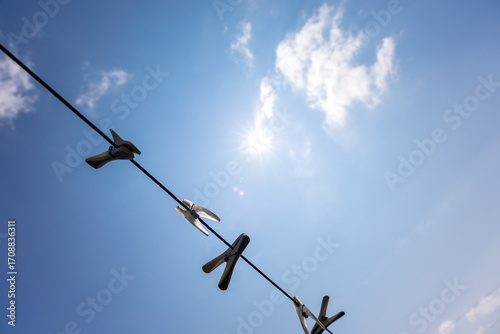 Clothespins on a Line Against Blue Sky