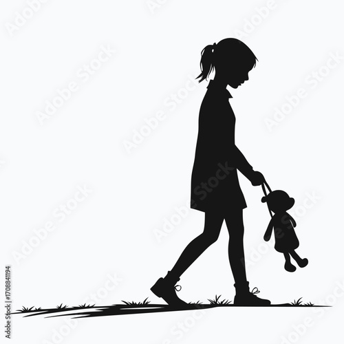 Girl standing with doll in hand