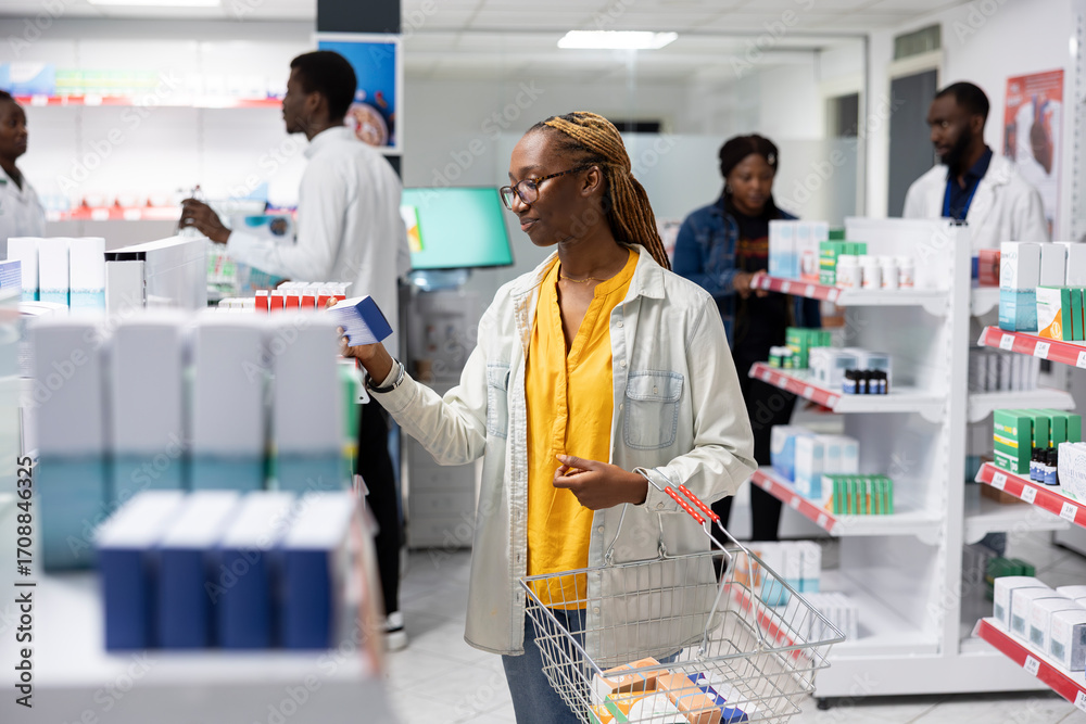 Fototapeta premium Pharmacy customer examining various prescription medicines and vitamins in a drugstore, seeking healthcare products for self care and effective treatment during a pharmacy visit.
