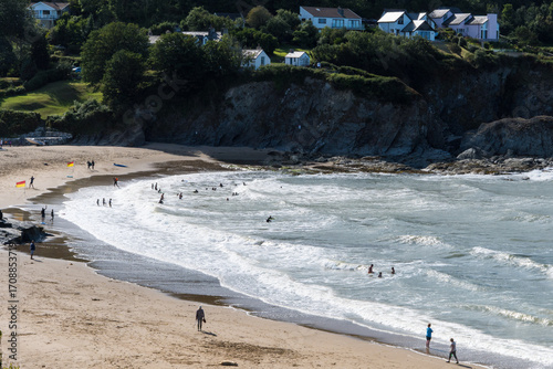 People enjoying the sea at a Lifeguard-patrolled area, Wales, UK