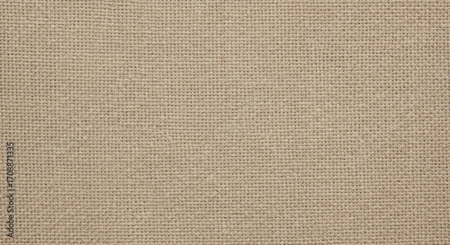 Close up of natural linen fabric texture for background in neutral beige color and detailed pattern