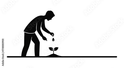 Man carefully watering a small plant, symbolizing growth and nurturing new life.