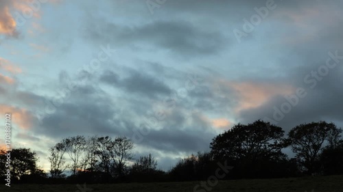 Time-Lapse of Clouds at Sunset Over Bare Winter Trees