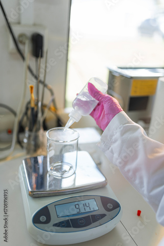 Liquid measurement on digital scale in laboratory