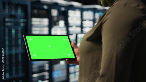 Wallpaper Mural Data center programmer uses green screen tablet to develop disaster recovery plans, minimizing downtime. IT expert in server farm, enhancing data protection protocols using chroma key device, camera B Torontodigital.ca