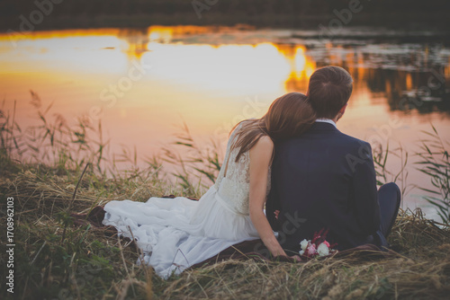 Back View of Newlyweds by the Lake at Sunset, for Wedding Design, Romantic Theme Materials, Love Atmosphere Creation