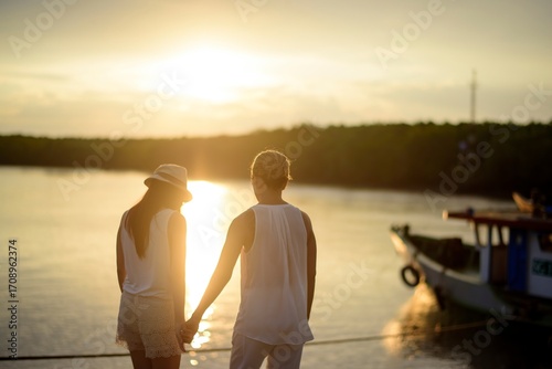 Couple Holding Hands by the Lake at Sunset, for Love - Themed Design, Romantic Atmosphere Creation, Travel Materials
