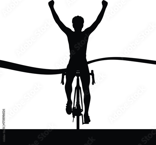 Male cyclist crossing finish line in victory silhouette
