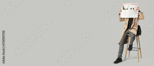 Male spy with newspaper sit...