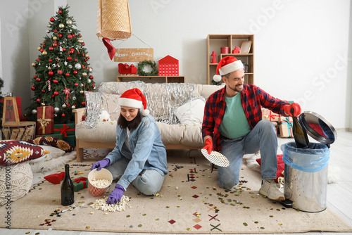 Young couple in Santa hats ...