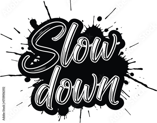 Handwritten text slow down in a black ink splash with paint splatters and drips on white background