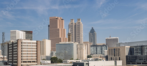 View of the Midtown, Downtown Atlanta Skyline showing several prominent buildings, and hotels under a blue sky.