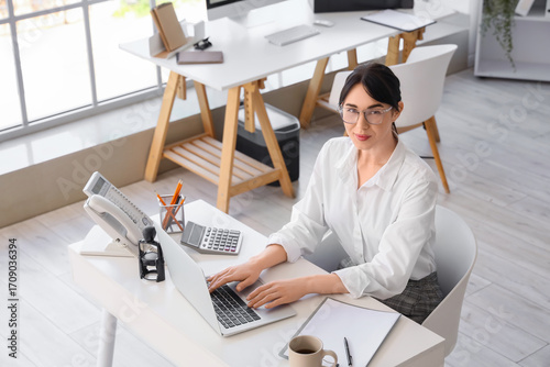Young businesswoman working...