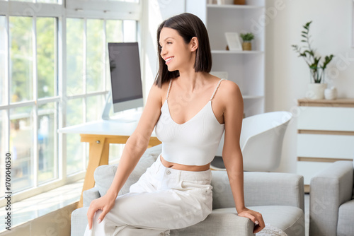 Beautiful young woman with short brown hair at home Free Download Beautiful young woman with short brown hair at home - GFXLoad