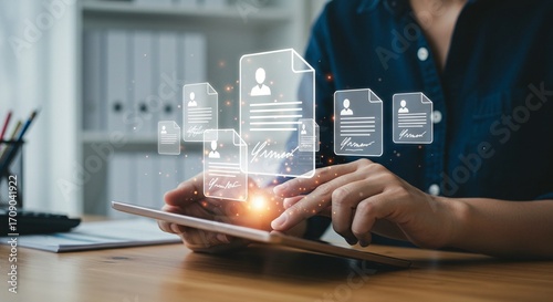 Digital resumes and applicant profiles are managed and accessed on a tablet, streamlining job applications and hiring.
