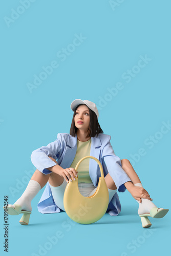 Stylish young woman in ligh...