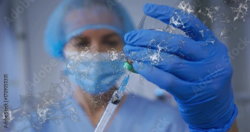 Medical nurse inverting vial and drawing using syringe for precise dose checking fluid level rise