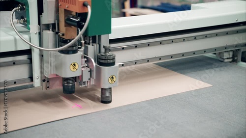 Crafting precision with an industrial plotter cutting through cardboard in a dynamic workspace setting