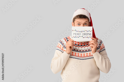 Happy young man in Santa ha...