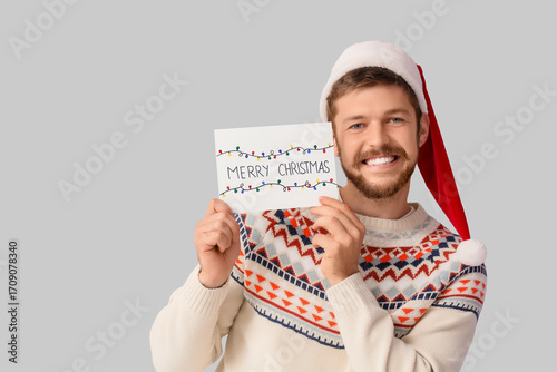 Happy young man in Santa ha...