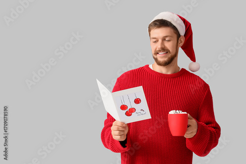 Happy young man in Santa ha...