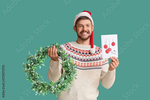 Happy young man in Santa ha...