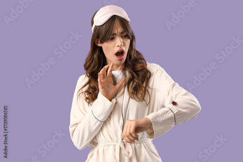 Scared young woman in pajam...