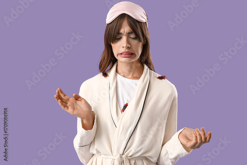 Scared young woman in pajam...