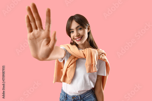 Young woman waving hand on ...