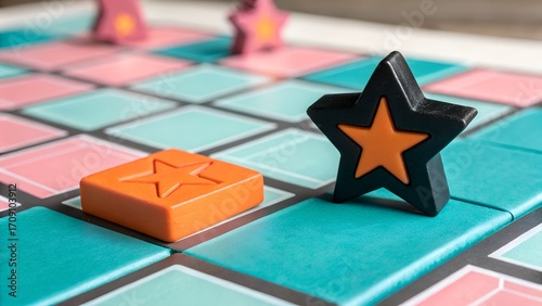 Colorful board game pieces including a black star and an orange square sit on a grid ready for players to begin a fun match.