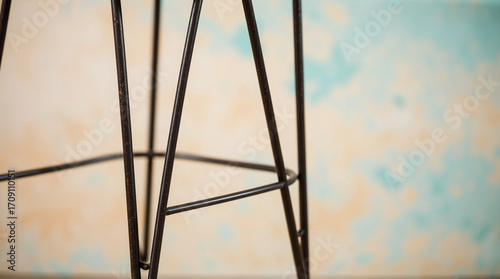 Wallpaper Mural Close-up shot steel stool with bent leg, warm terracotta and cool teal tones, earthy and cool contrast, detailed focus Torontodigital.ca
