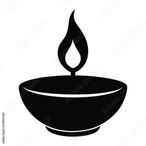 Black silhouette of a traditional oil lamp with a vibrant flame burning brightly