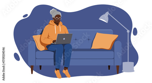 A senior African American woman comfortably works from home on her laptop, embracing modern technology and a relaxed lifestyle.