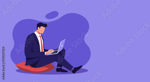 Professional man in a suit works on a laptop while sitting comfortably on a cushion. Depicts remote work, flexibility, and modern business.
