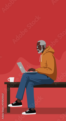 An older African American man with a gray beard and glasses sits on a bench, intently working on his laptop, enjoying a hot beverage.
