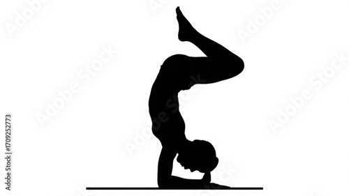 Silhouette of woman practicing yoga handstand pose for fitness and wellness exercise and healthy lifestyle