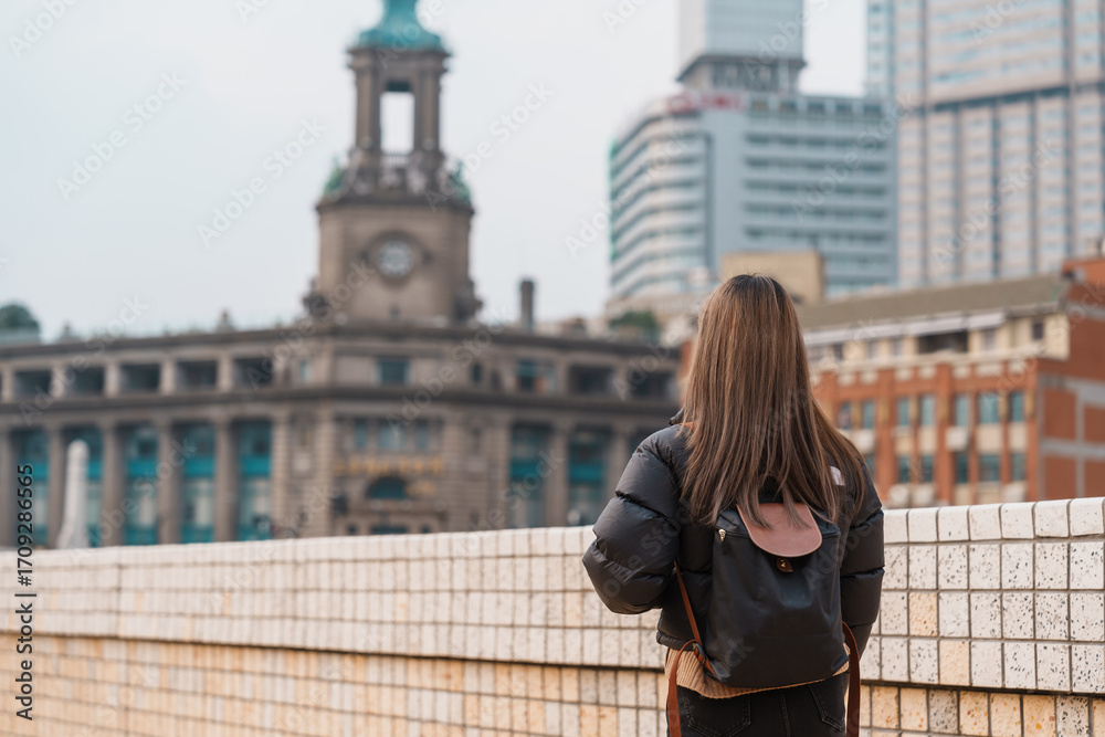 Fototapeta premium woman traveler visiting in Shanghai, China. Happy Female Tourist sightseeing Shanghai view. landmark and popular for tourism attractions. Travel and vacation concept