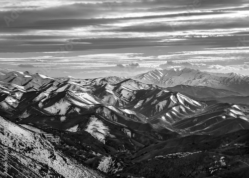 Snow-Covered Mountains in Black and White – Dramatic Landscape with Cloud-Filled Sky